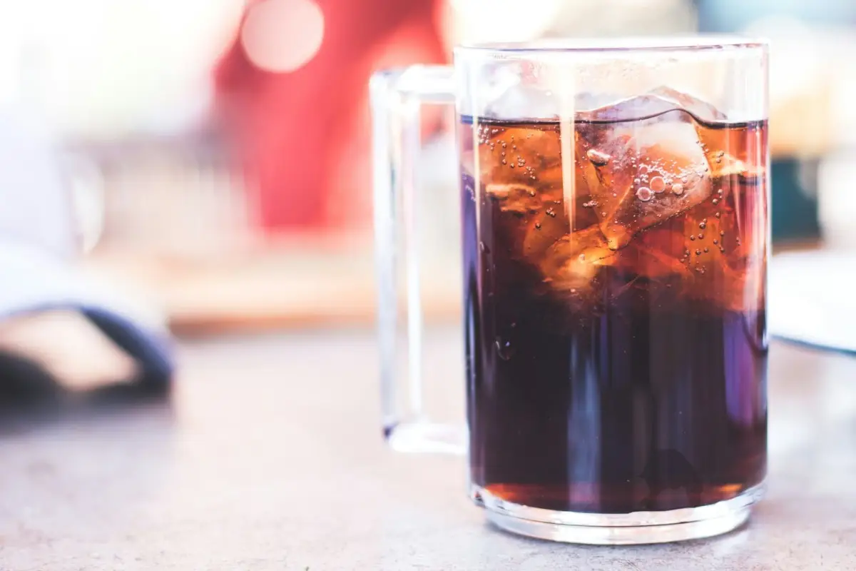 A glass of tea sitting on top of a table